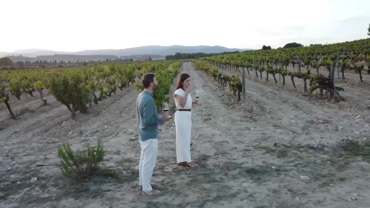Pablo and Rosa walking among the vines