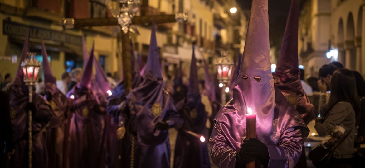 Crowd in costumes in Semana Santa Festival captured in Seville, Spain